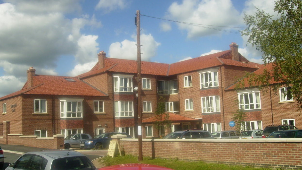 View of building with carpark with post 